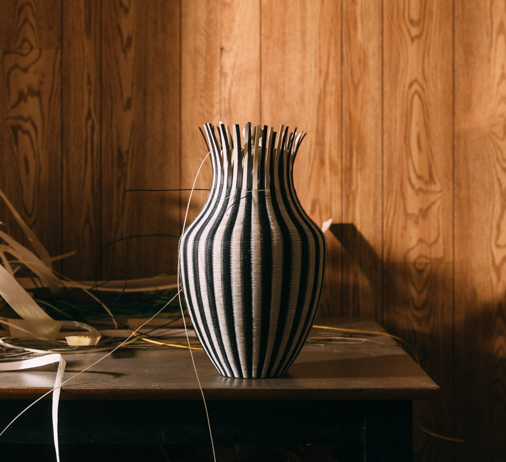 An in-progress woven basket in an artist's studio.