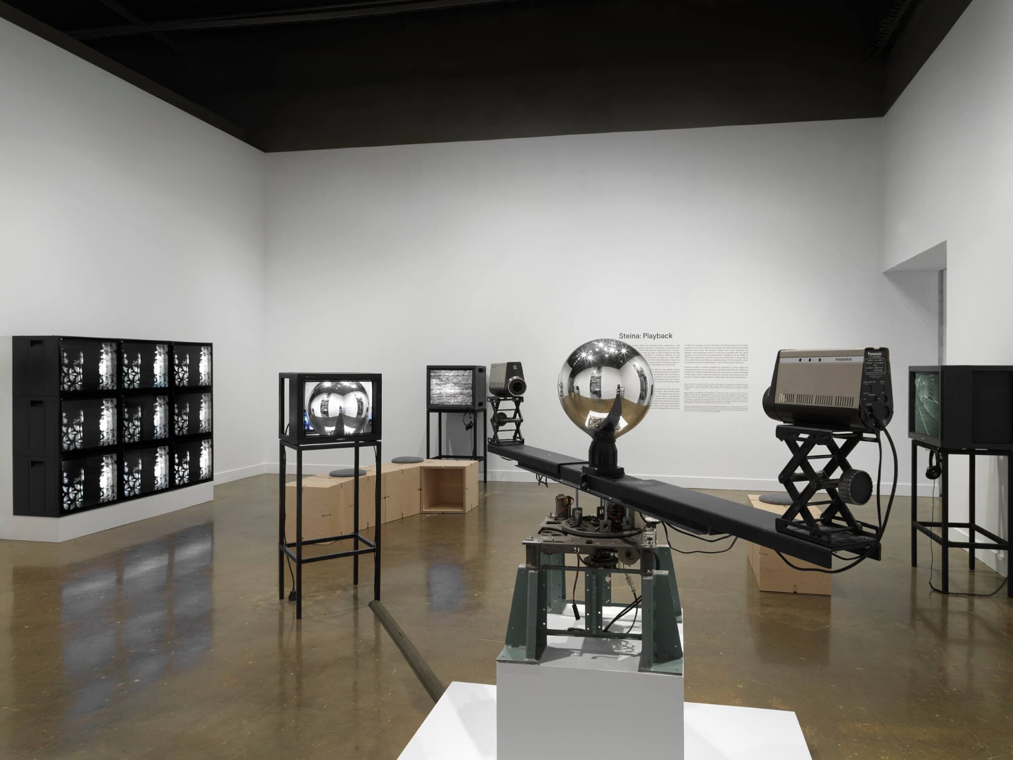 Technological art pieces in a gallery space.